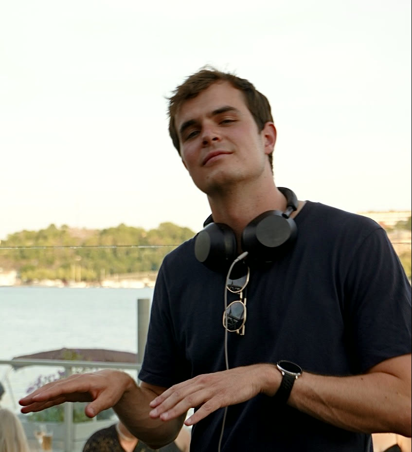 Owen Joxef mid-set at a rooftop venue by the water